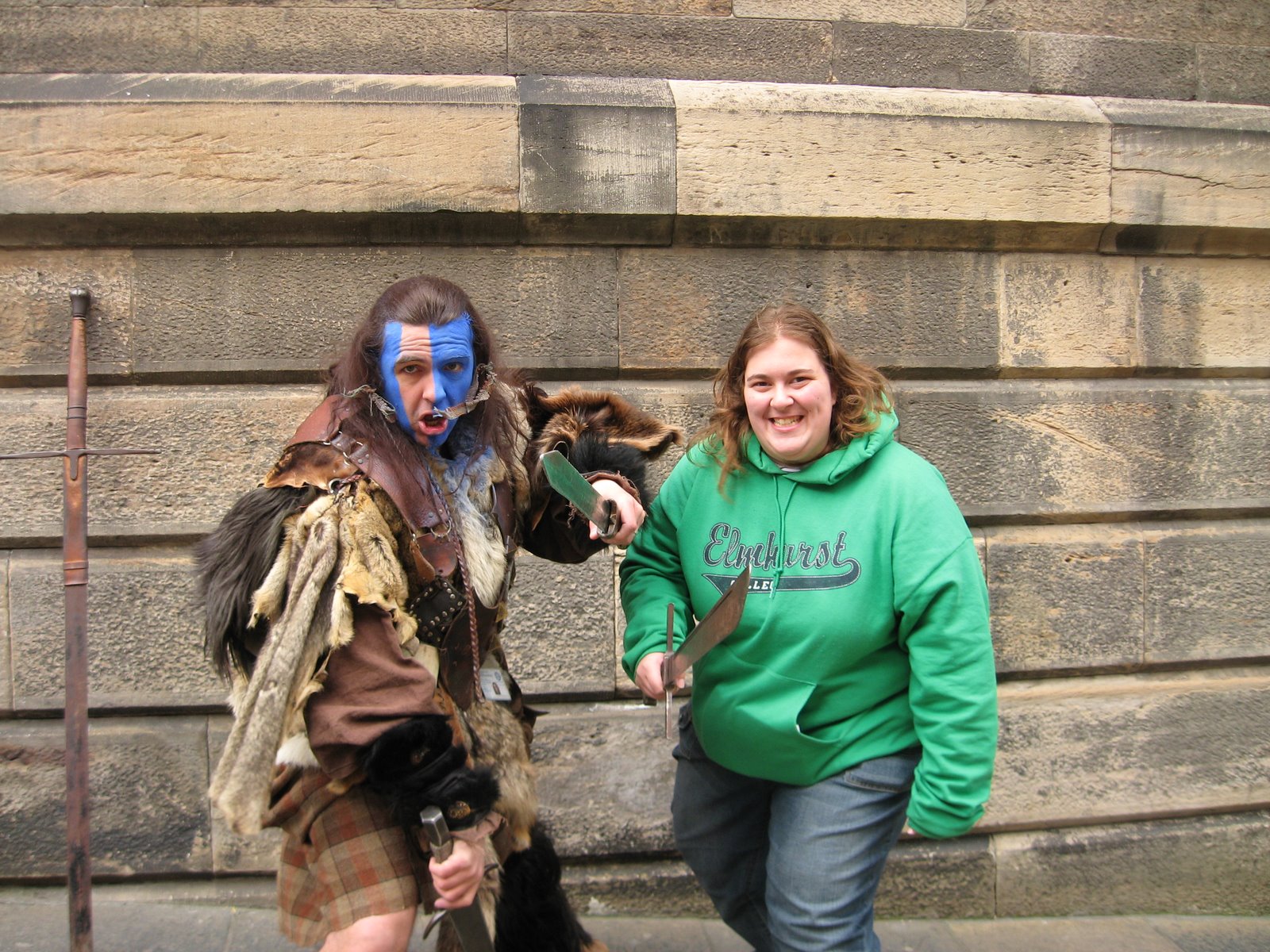 William Wallace impersonator and college girl holding swords.