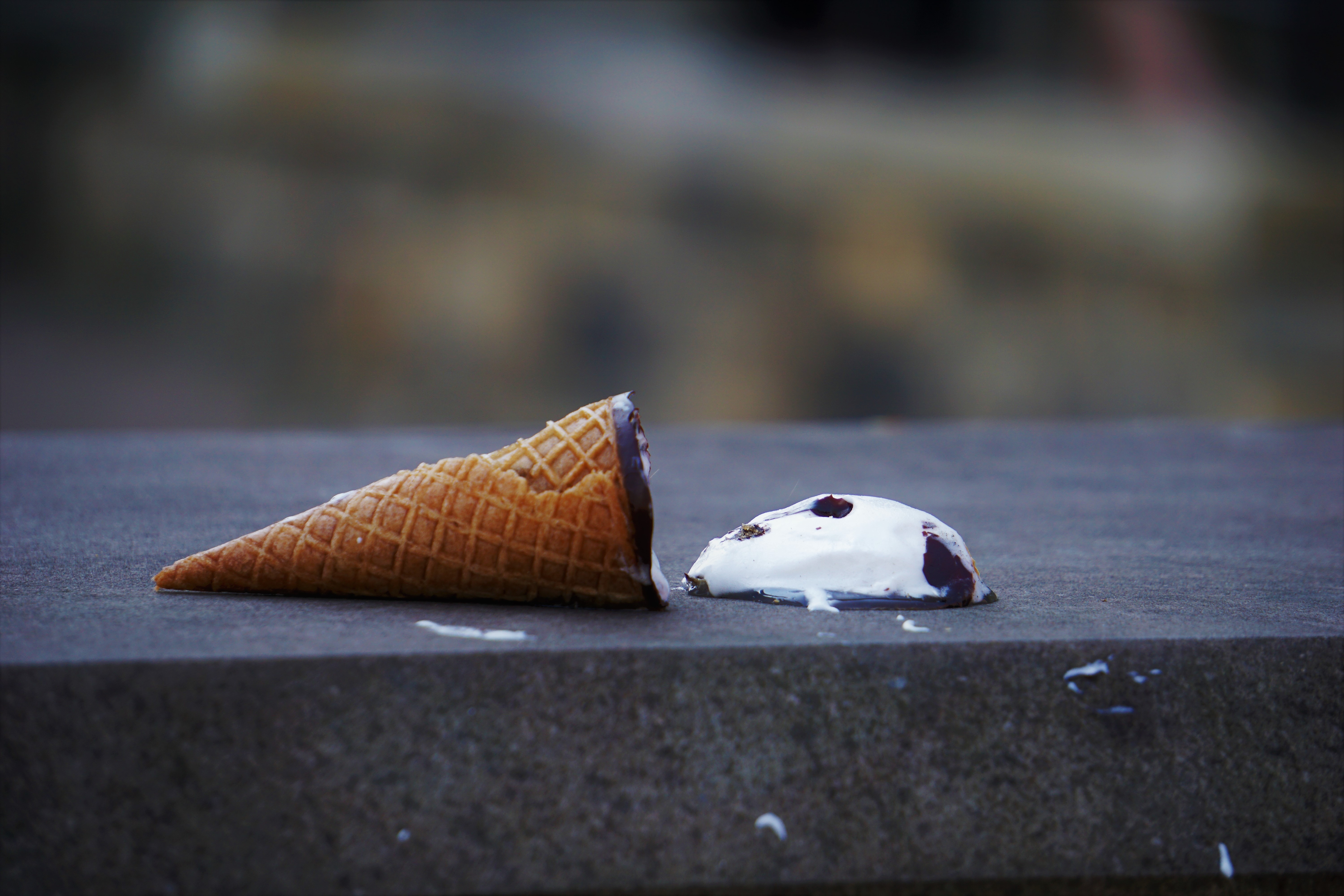 Ice cream cone fallen on concrete